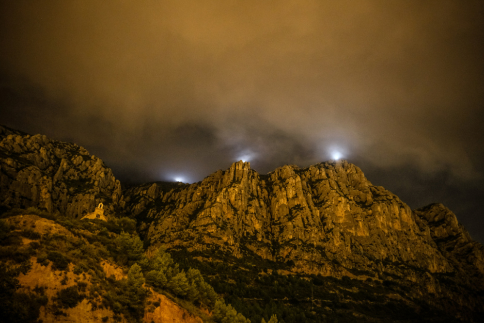 Montserrat, il·luminada, des de la carretera d'accés a les Coves de Collbató